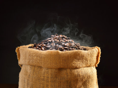 Coffee beans with smoke in burlap sack