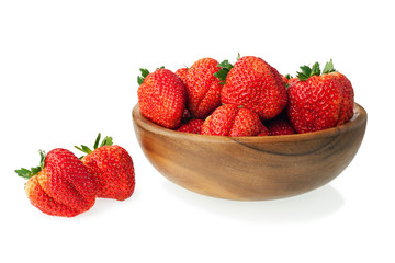 Fresh ripe strawberries in wooden bowl isolated on white backgro