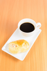 black coffee and bread ,coffee break on wooden background