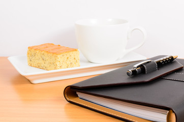 black organizer with coffee and  cake ,coffee break