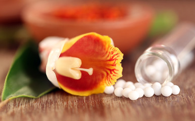 Fototapeta na wymiar Homeopathy globules with herbal flower