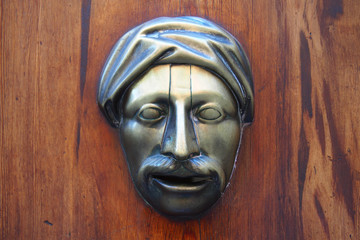 Metallic face at an old door, Valencia