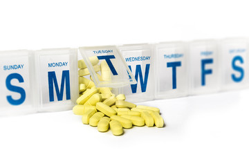 Pills spill out of a dossette box