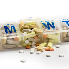 Pills spill out of a dossette box