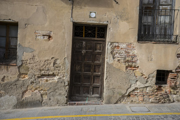 Street, medieval door Spanish city of Segovia. Old wooden entran