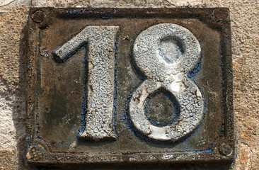 Old retro cast iron plate with number 18 on it