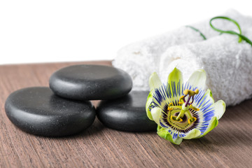beautiful spa still life of passiflora flower, black zen stones
