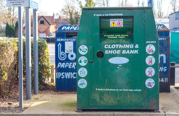 A collection bin for second hand clothes and shoes in a carpark