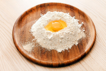 Broken egg on flour
