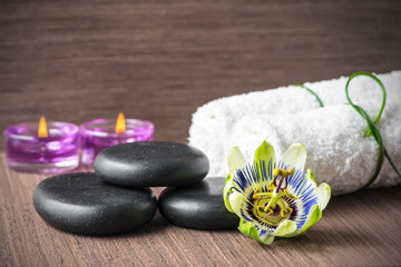 beautiful spa concept of passiflora flower, black zen stones, pu