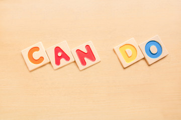 CAN DO word wooden alphabets on wood table