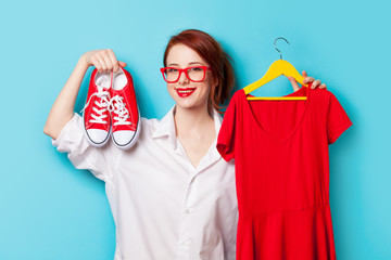 Young redhead designer with dress and gumshoes