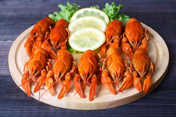 cooked cancer with lemon and leaf lettuce on the table