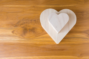 wood box shaped heart on brown wooden background