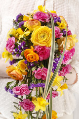 Bouquet with ranunculus, daffodil and carnation flowers