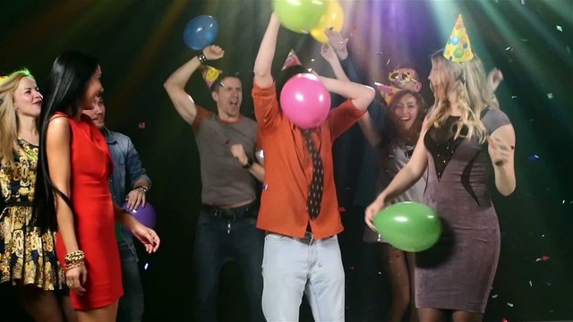 Friends dancing the nightclub fray streamers and they throw