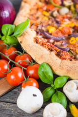 Fresh homemade vegetarian pizza with ingredients, overhead
