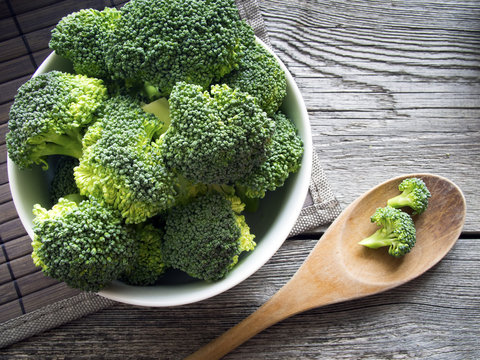 Healthy fresh broccoli on dark wooden background