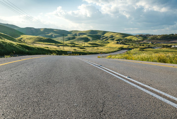 Highway across green hills