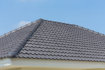 Fototapeta premium black roof tiles on house with blue sky