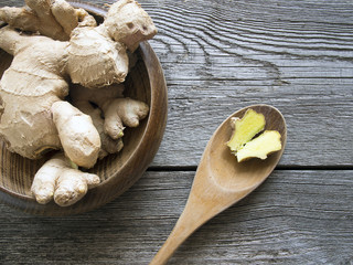 Fresh dry ginger on dark wooden background
