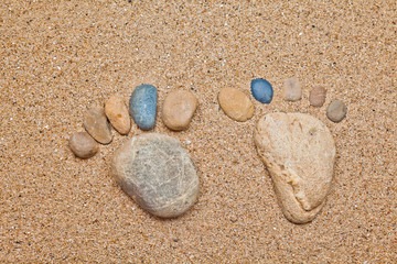 Fototapeta na wymiar Stone foot in the sand