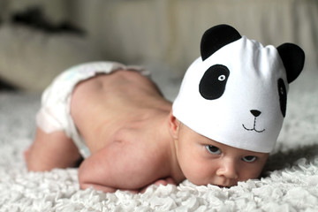 Baby boy in funny hat panda