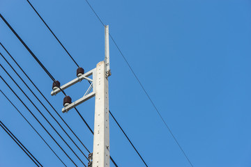 electricity post with clear blue sky