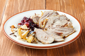 Slices of roasted duck with apple rice and cherry souce
