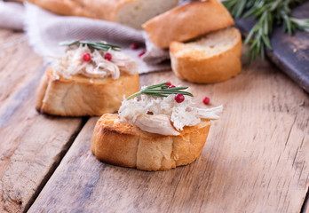 Toast bread with chicken pate on wooden desk.
