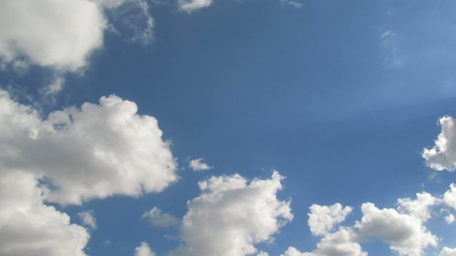 Summer sky timelapse. Clouds fast running over blue sky