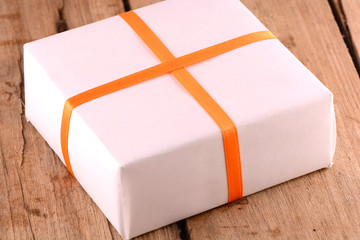 white gift box on wooden plate