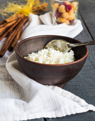cottage cheese in an earthenware dish, shelves cinnamon, cup ras
