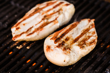 Grilled chicken breast fillets on BBQ