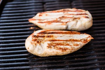 Grilled chicken breast fillets on BBQ