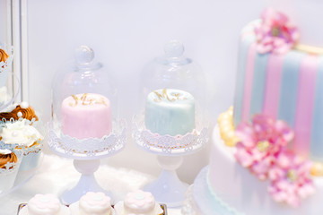 Wedding cakes in cream and pink with pearls.