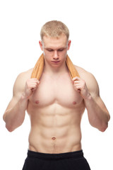 Happy muscular guy with towel over white background