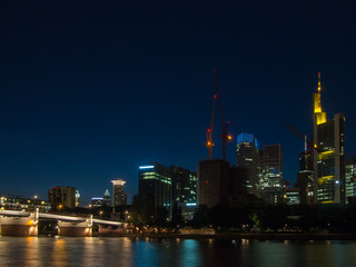 Fototapeta na wymiar Scyscrapers at the river Main in Frankfurt, Germany, at night