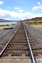 Railroad tracks running along Columbia river banks.