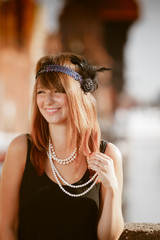 Flapper girl woman in1920s style portrait outdoor