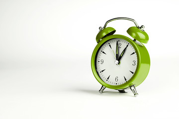 One o'clock. Green classic clock on white background.