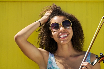 Smiling African American woman with hand in hair