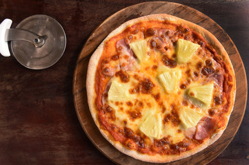 Hawaiian Pizza , pineapple , ham and cheese on wooden background