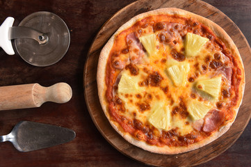 Hawaiian Pizza , pineapple , ham and cheese on wooden background
