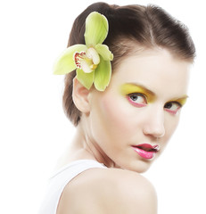 Beautiful stylish girl with orchid flower in hair.