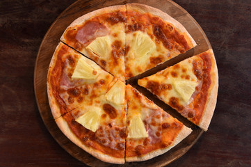 Hawaiian Pizza , pineapple , ham and cheese on wooden background