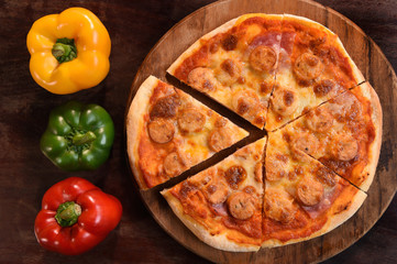 pizza and fresh vegetables for pizza on the wooden background