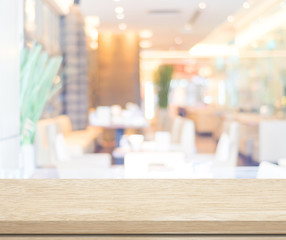 Empty wood table and blurred cafe with bokeh light background