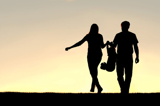 Silhouette of Family of Three People Walking at Sunset