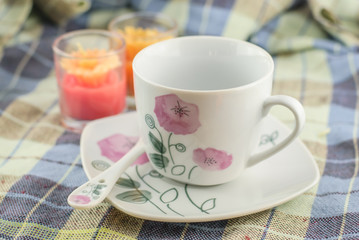 cup of coffee on fabric